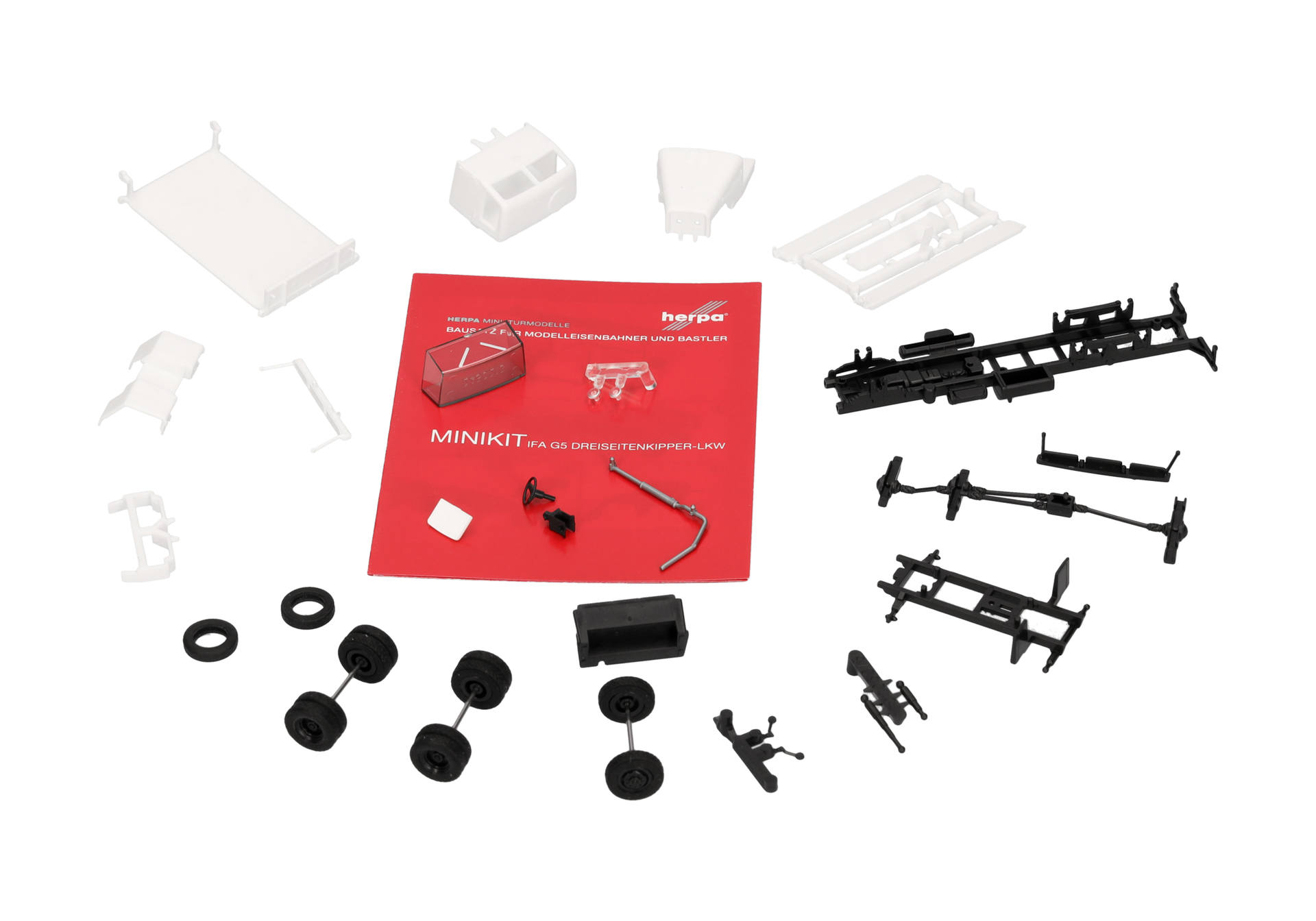 modellbahnset, gleisbau-teile, räder, weiße und schwarze teile, anleitung, modellbahn, gleise, bausatz, rad, anleitung